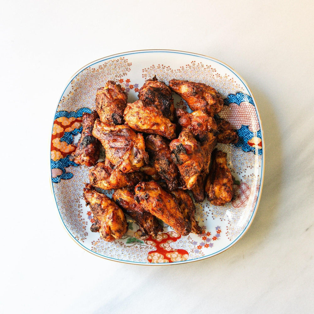 Square serving plate with white base featuring Japanese landscape of trees clouds and red maple leaves.