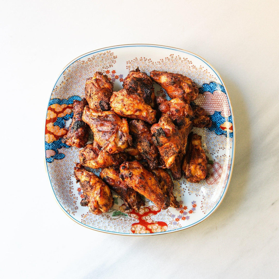 Square serving plate with white base featuring Japanese landscape of trees clouds and red maple leaves.
