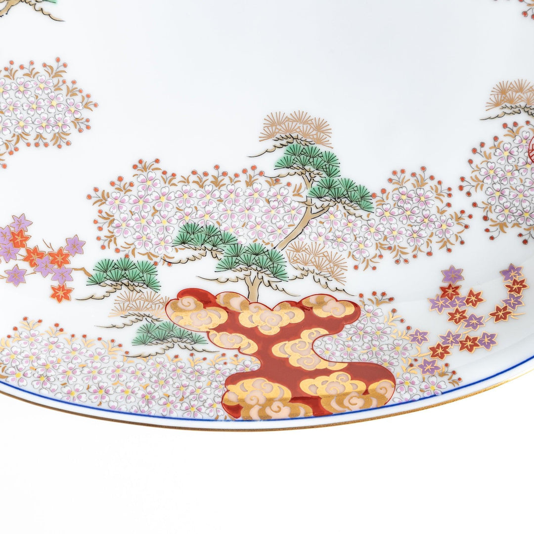 Square serving plate with white base featuring Japanese landscape of trees clouds and red maple leaves.