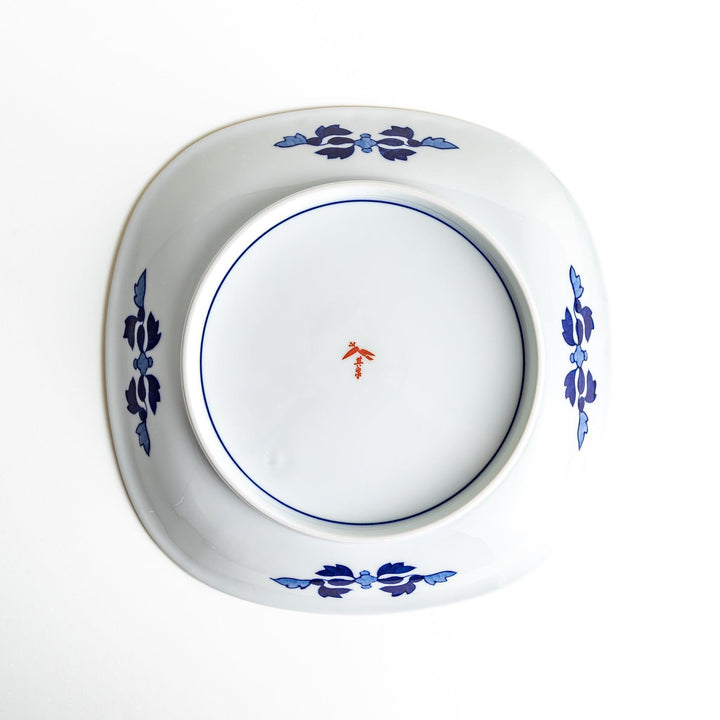 Square serving plate with white base featuring Japanese landscape of trees clouds and red maple leaves.