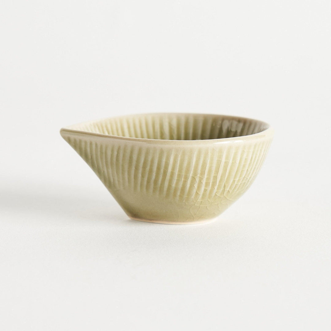 A small condiment bowl with a light green textured surface.