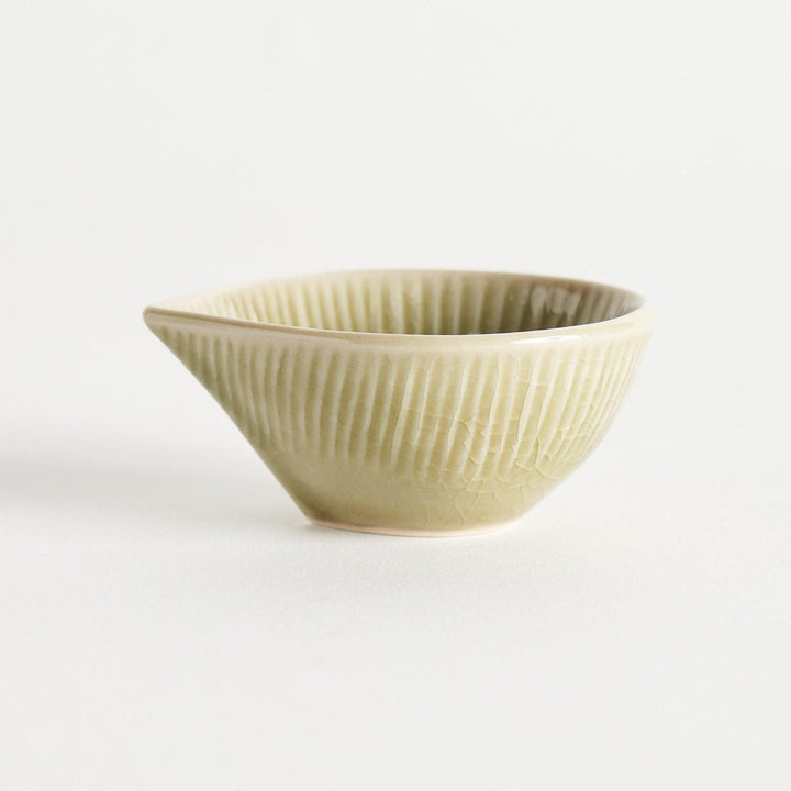 A small condiment bowl with a light green textured surface.