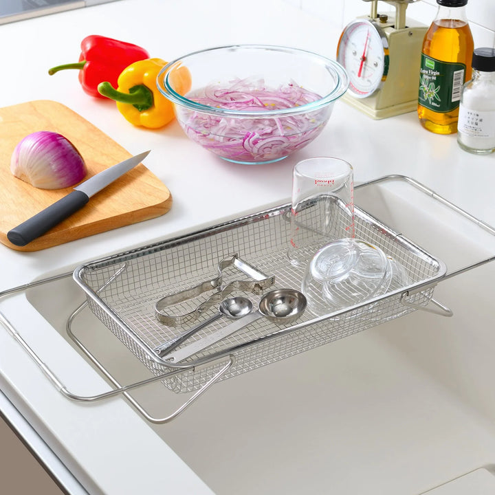 Fine mesh stainless steel draining basket, ideal for washing or draining ingredients during food preparation.