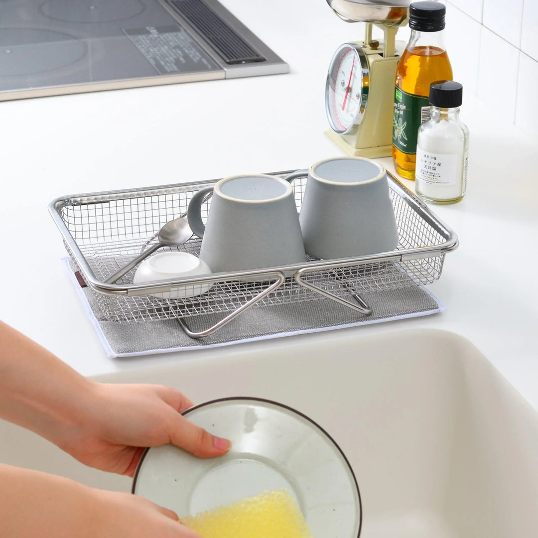 Fine mesh stainless steel draining basket, ideal for washing or draining ingredients during food preparation.
