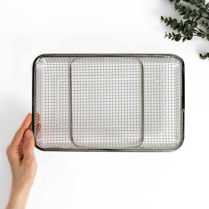 Fine mesh stainless steel draining basket, ideal for washing or draining ingredients during food preparation.