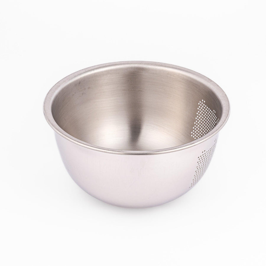 Japanese stainless steel rice washing bowl with perforated and slotted drainage sections for quick rinsing.
