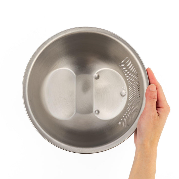 Japanese stainless steel rice washing bowl with perforated and slotted drainage sections for quick rinsing.
