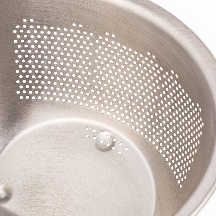 Japanese stainless steel rice washing bowl with perforated and slotted drainage sections for quick rinsing.