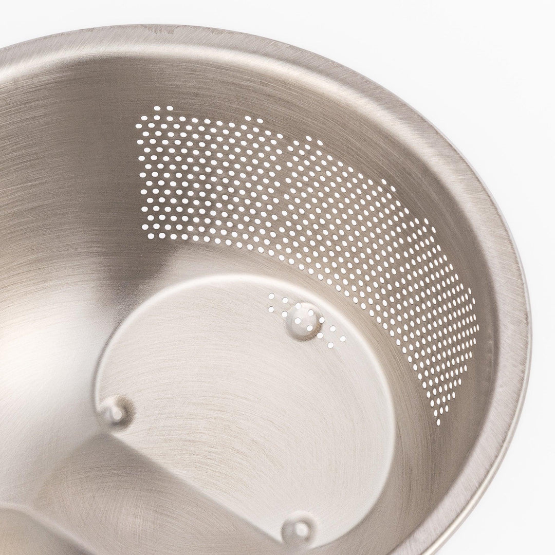 Japanese stainless steel rice washing bowl with perforated and slotted drainage sections for quick rinsing.