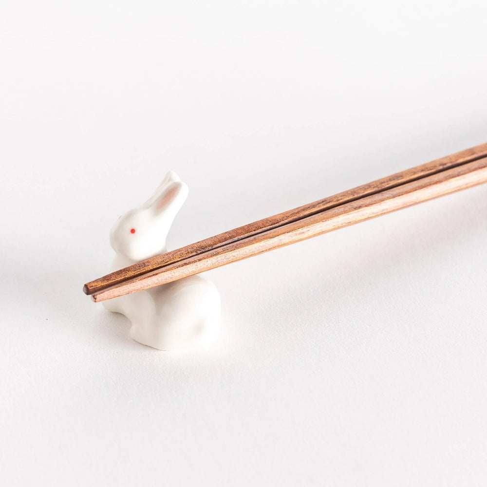 Standing rabbit shaped ceramic chopstick rest with gentle expression adding cute accent to dining.