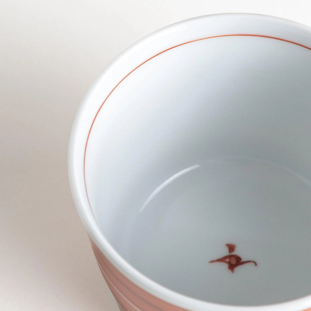 A small condiment bowl with horizontal blue or red stripes of varying shades, creating a minimalist yet elegant design.