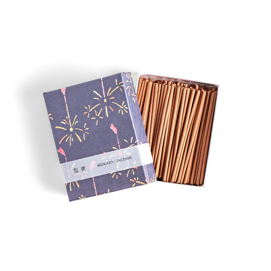 Japanese incense with brown sticks in dark blue box decorated with fireworks for soothing summer aroma.