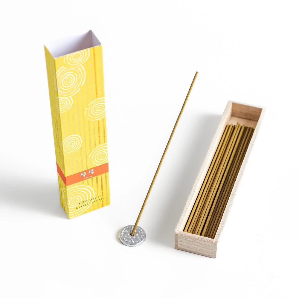 Japanese lemon incense sticks in a wooden box with a bright yellow patterned sleeve from Kyoto’s Kousaido