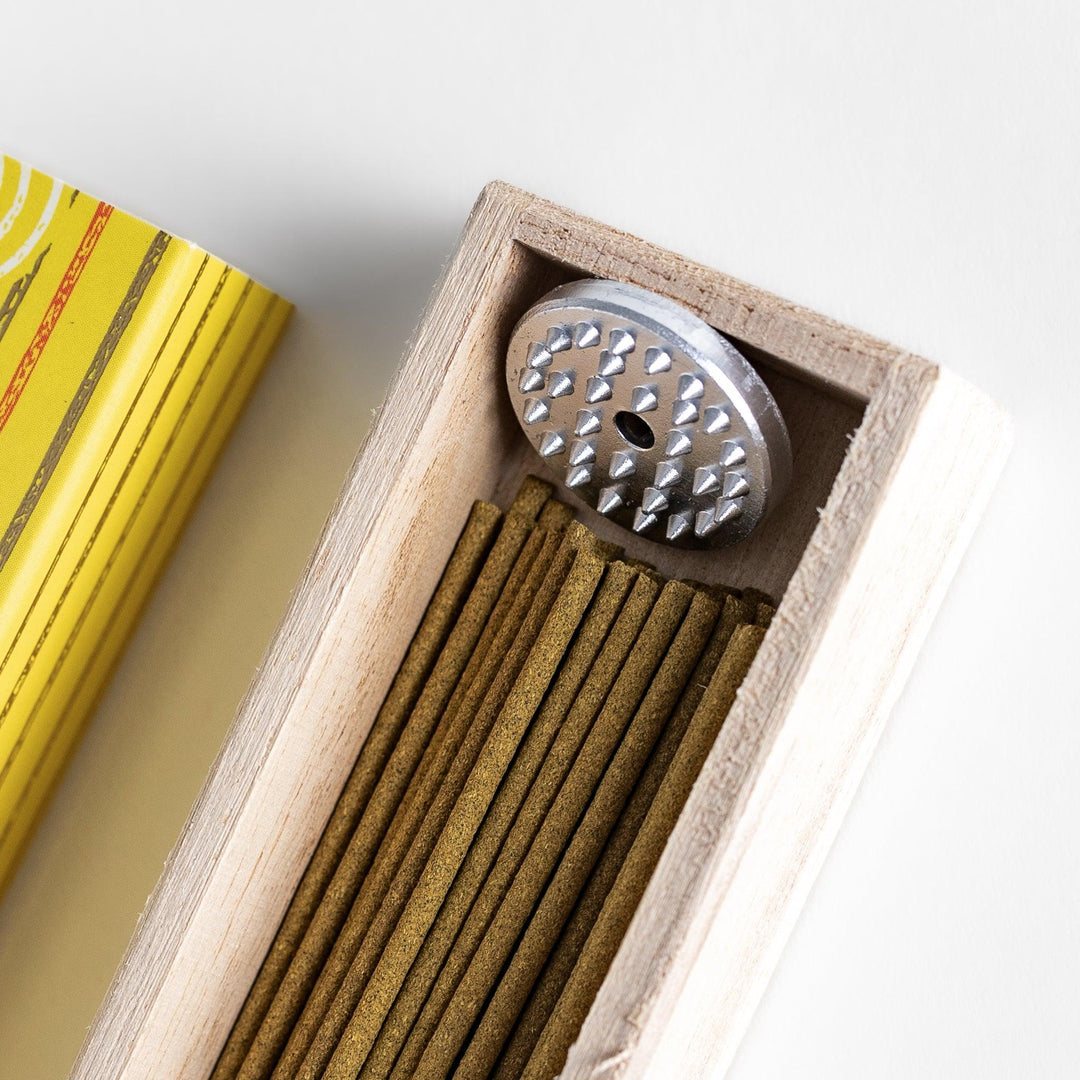 Japanese lemon incense sticks in a wooden box with a bright yellow patterned sleeve from Kyoto’s Kousaido