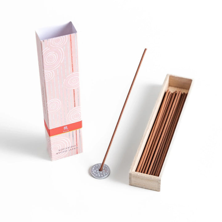 Peach scented Japanese incense sticks from Kyoto in a patterned box, offering a soft fruity aroma for a calming atmosphere.