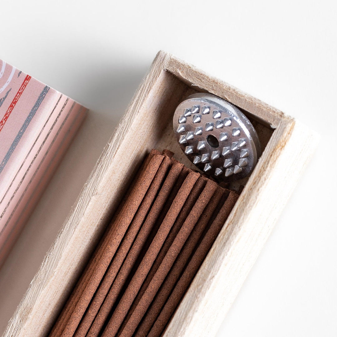 Peach scented Japanese incense sticks from Kyoto in a patterned box, offering a soft fruity aroma for a calming atmosphere.