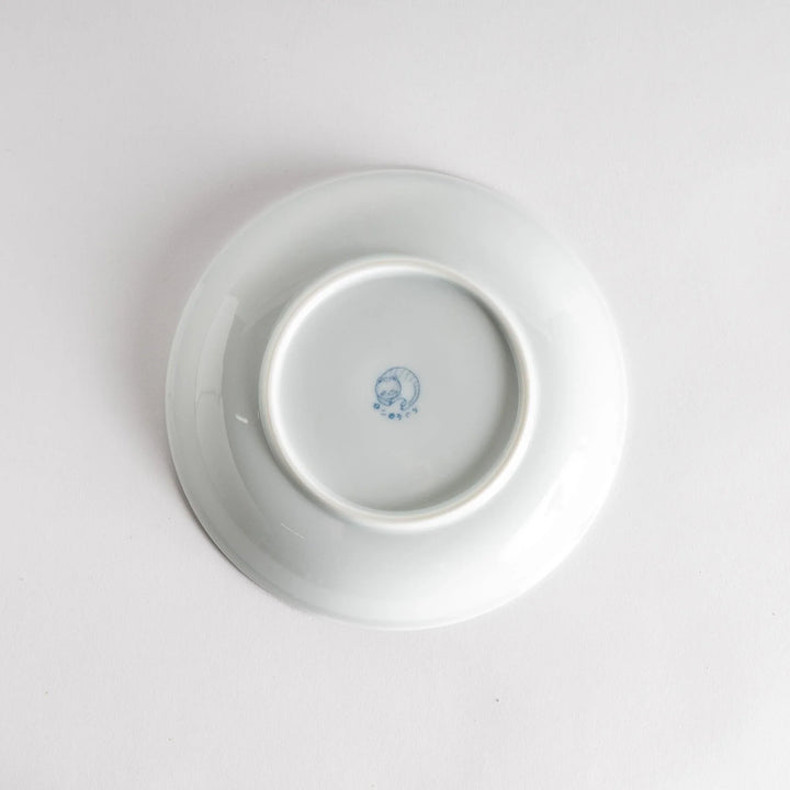 A salad plate with a blue-striped white cat, smiling with closed eyes.