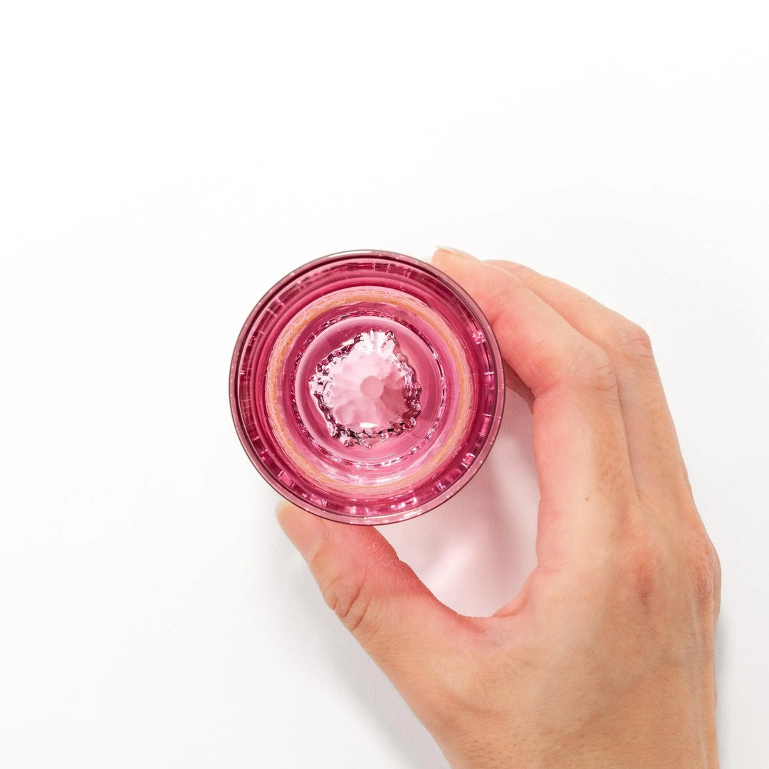 Pink sake glass with gold-leaf mountain and Mount Fuji base, perfect for festive and elegant occasions.