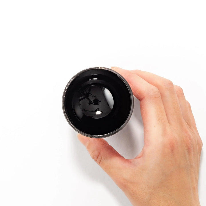 Black and clear sake glass with gold-leaf landscape and Mount Fuji base, offering bold Japanese elegance.