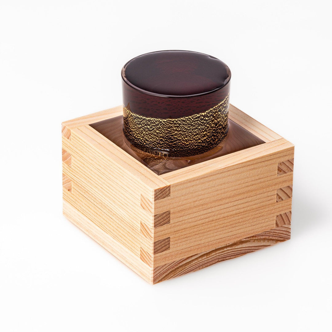 Deep red sake glass with gold-leaf mountain and Mount Fuji base, showcasing refined Japanese craftsmanship.