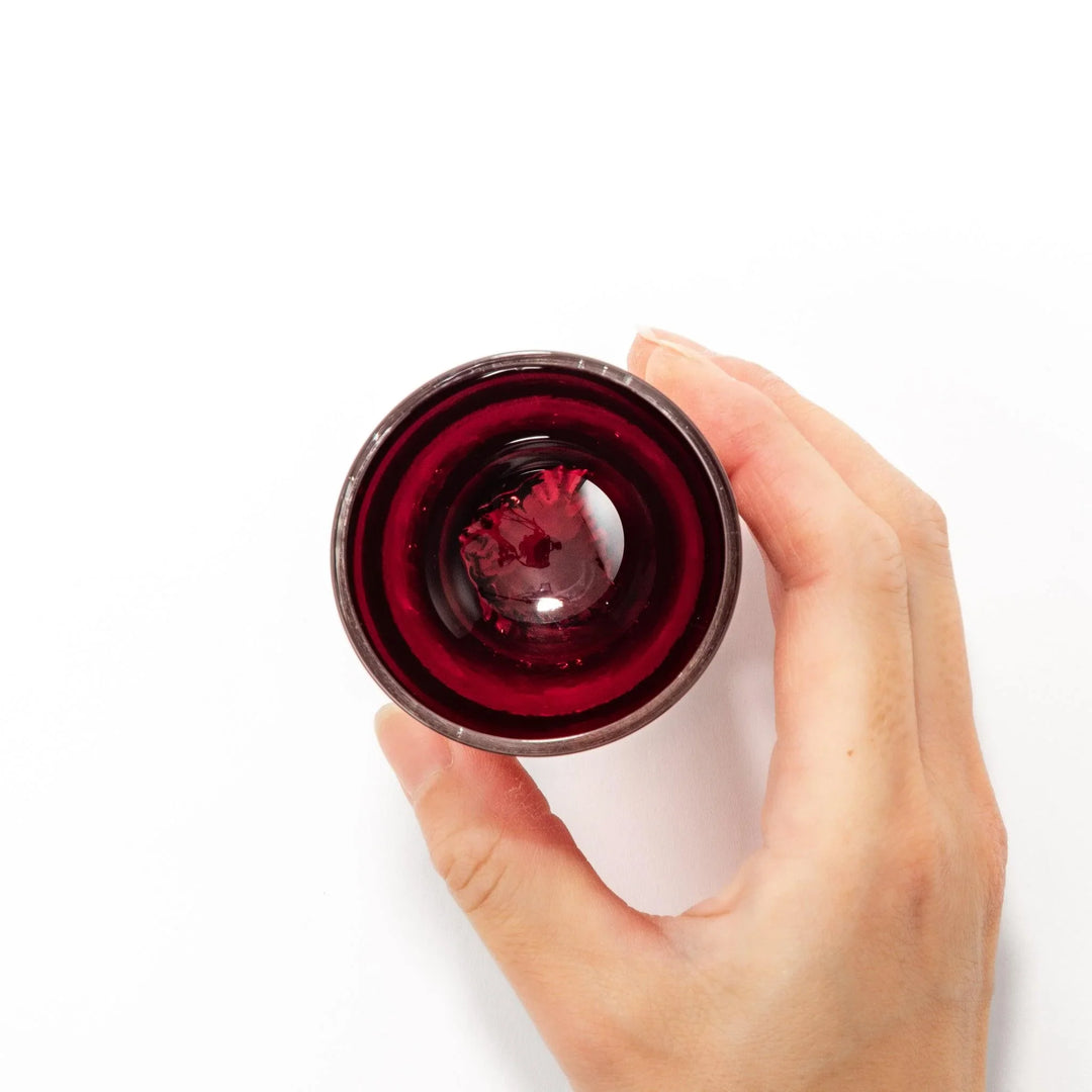 Deep red sake glass with gold-leaf mountain and Mount Fuji base, showcasing refined Japanese craftsmanship.