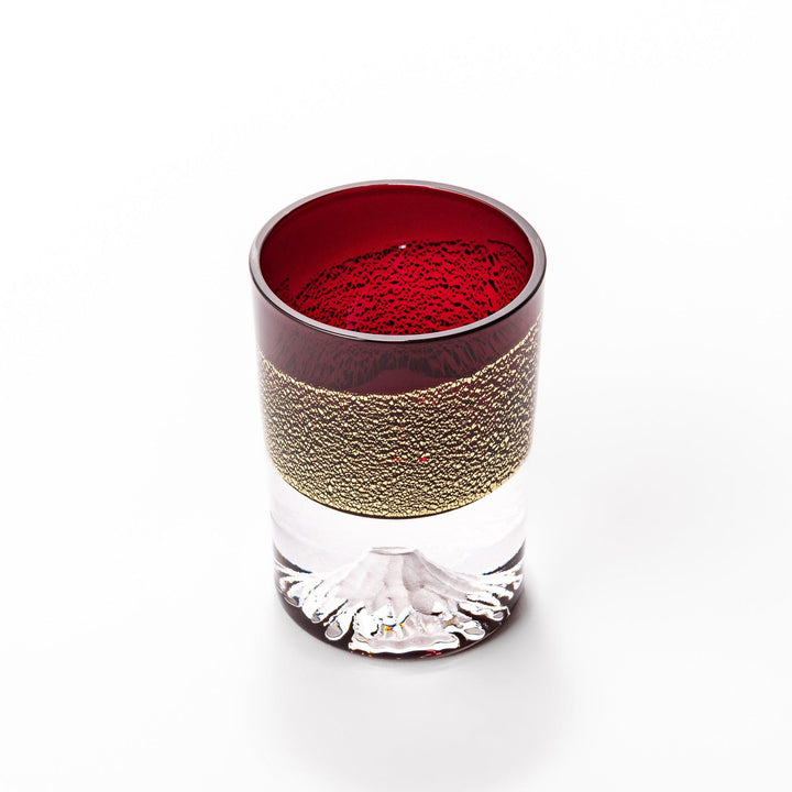 Deep red sake glass with gold-leaf mountain and Mount Fuji base, showcasing refined Japanese craftsmanship.