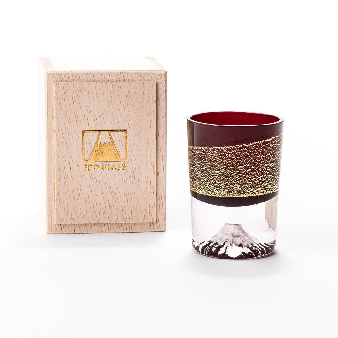 Deep red sake glass with gold-leaf mountain and Mount Fuji base, showcasing refined Japanese craftsmanship.