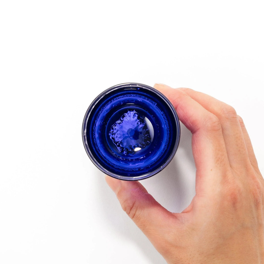 Deep blue sake glass with gold-leaf mountain and Mount Fuji base, blending traditional design with refined artistry.