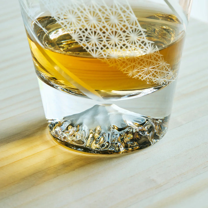 Close-up of a Kiriko Japanese whiskey glass featuring Mt. Fuji design at the base and traditional Asanoha patterns.