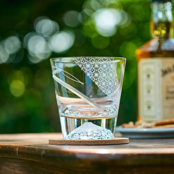 Clear Japanese Kiriko whiskey glass with slanted Asanoha engravings and Mt. Fuji-shaped base.