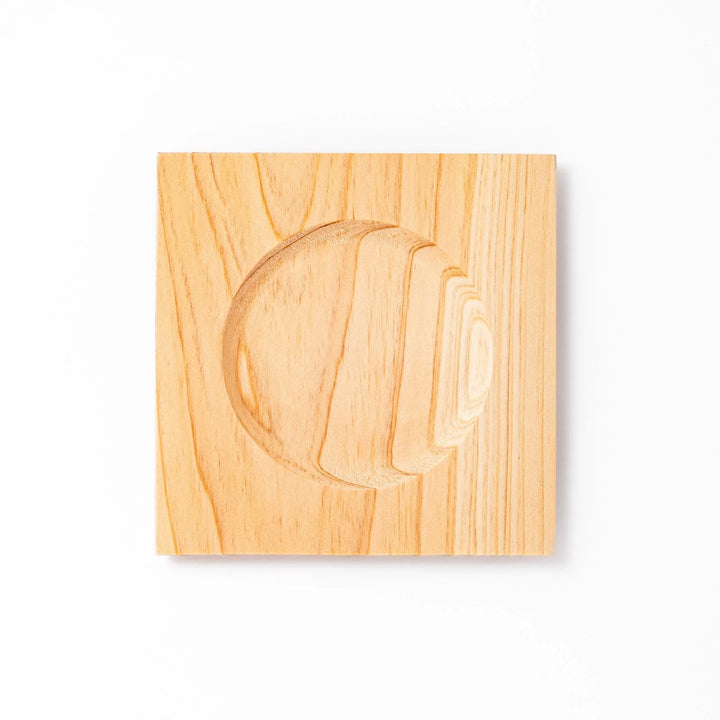 Square hinoki wood coaster with recessed circular center and beveled edge, featuring natural grain for elegant cup support.