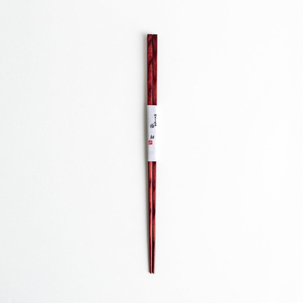 A pair of simple thin lacquered chopsticks with a minimalist design, perfect for everyday use. Available in red or black.