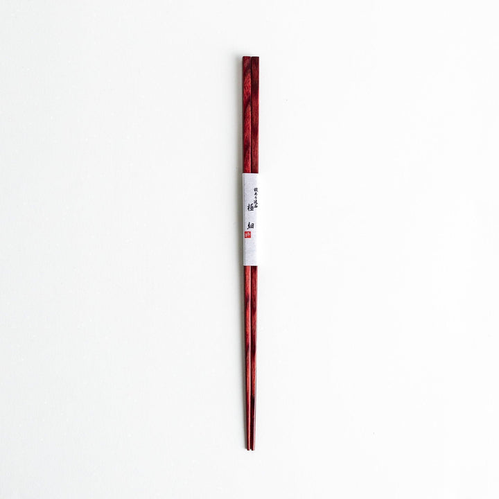 A pair of simple thin lacquered chopsticks with a minimalist design, perfect for everyday use. Available in red or black.