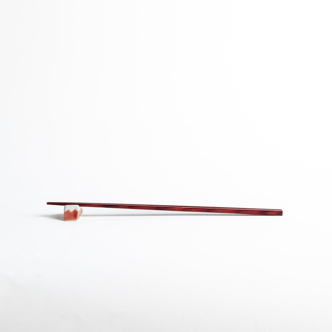 A pair of simple thin lacquered chopsticks with a minimalist design, perfect for everyday use. Available in red or black.