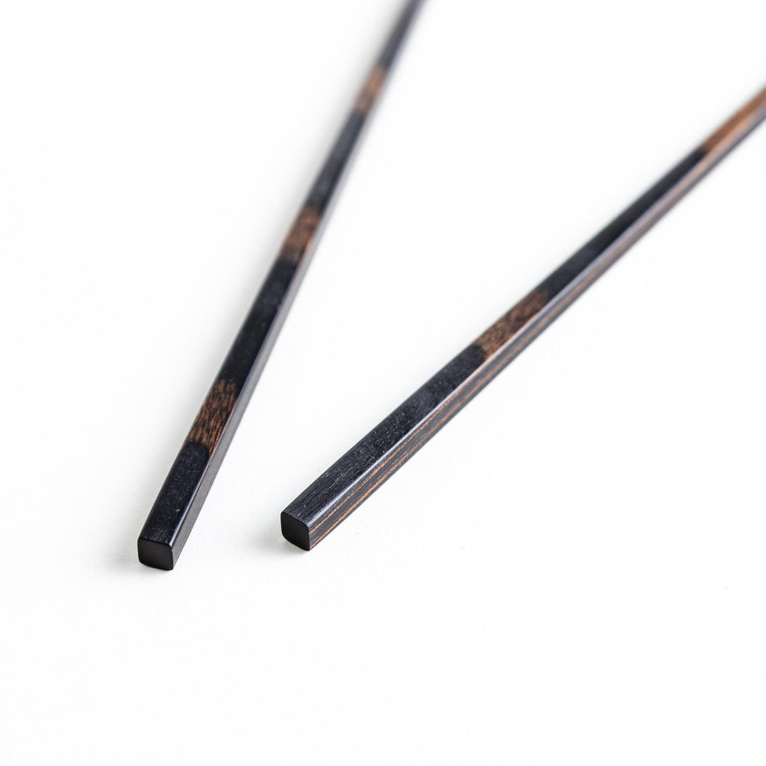 A pair of simple thin lacquered chopsticks with a minimalist design, perfect for everyday use. Available in red or black.