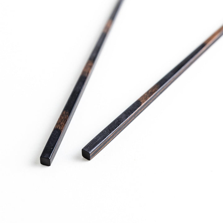 A pair of simple thin lacquered chopsticks with a minimalist design, perfect for everyday use. Available in red or black.