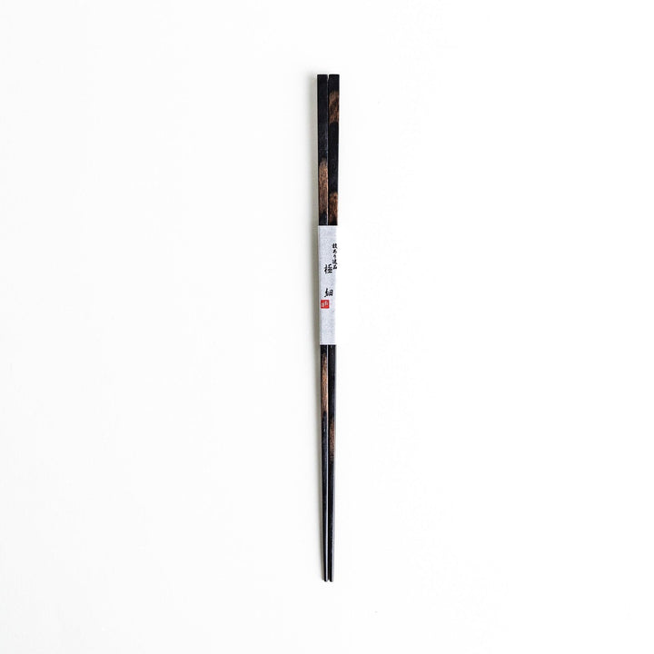 A pair of simple thin lacquered chopsticks with a minimalist design, perfect for everyday use. Available in red or black.