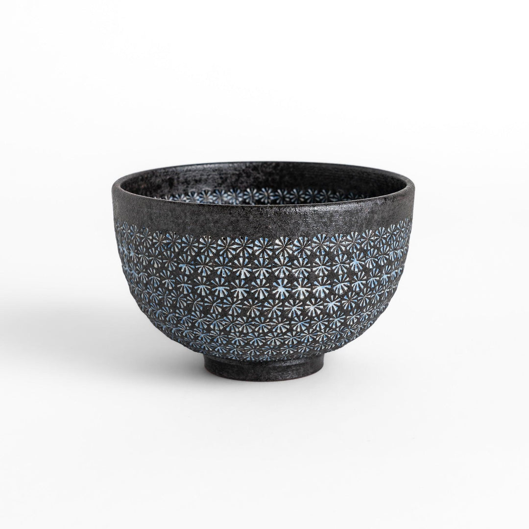 Stunning black Matcha bowl featuring a mesmerizing mosaic-like pattern, perfect for a traditional Japanese tea ceremony.