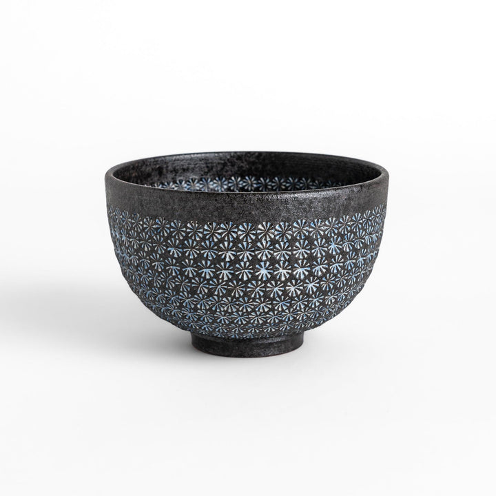 Stunning black Matcha bowl featuring a mesmerizing mosaic-like pattern, perfect for a traditional Japanese tea ceremony.
