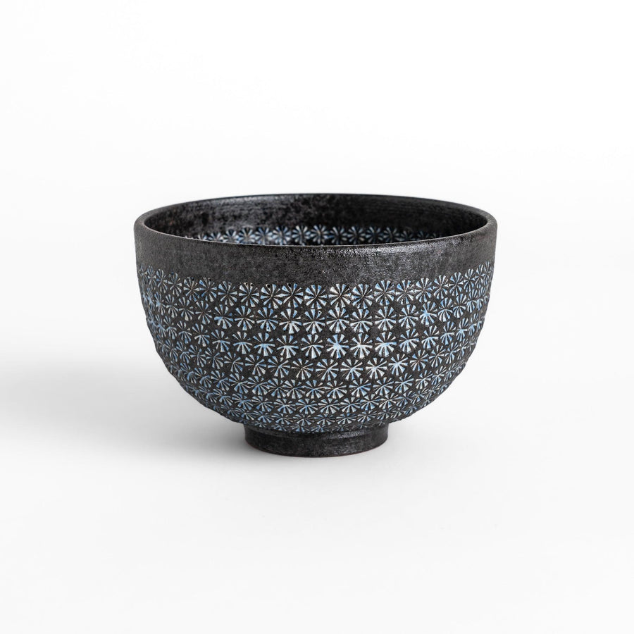 Stunning black Matcha bowl featuring a mesmerizing mosaic-like pattern, perfect for a traditional Japanese tea ceremony.