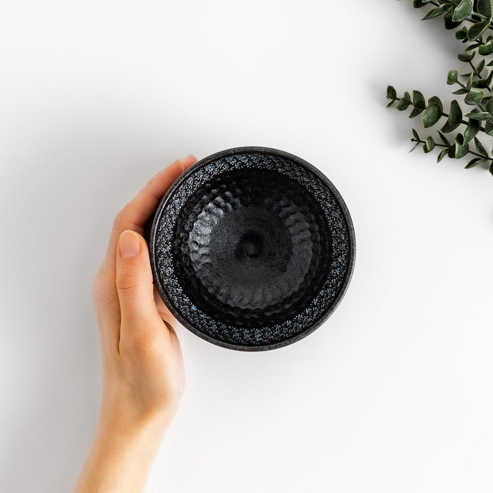 Stunning black Matcha bowl featuring a mesmerizing mosaic-like pattern, perfect for a traditional Japanese tea ceremony.