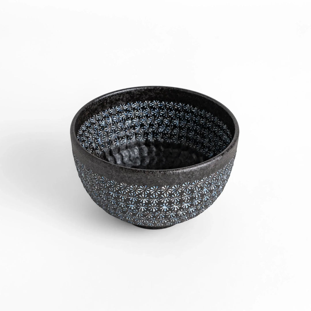 Stunning black Matcha bowl featuring a mesmerizing mosaic-like pattern, perfect for a traditional Japanese tea ceremony.
