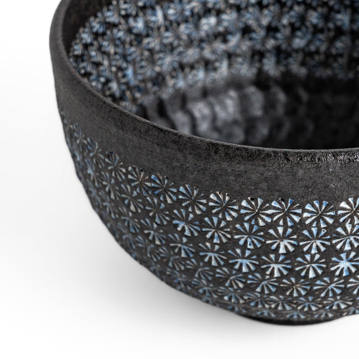 Stunning black Matcha bowl featuring a mesmerizing mosaic-like pattern, perfect for a traditional Japanese tea ceremony.