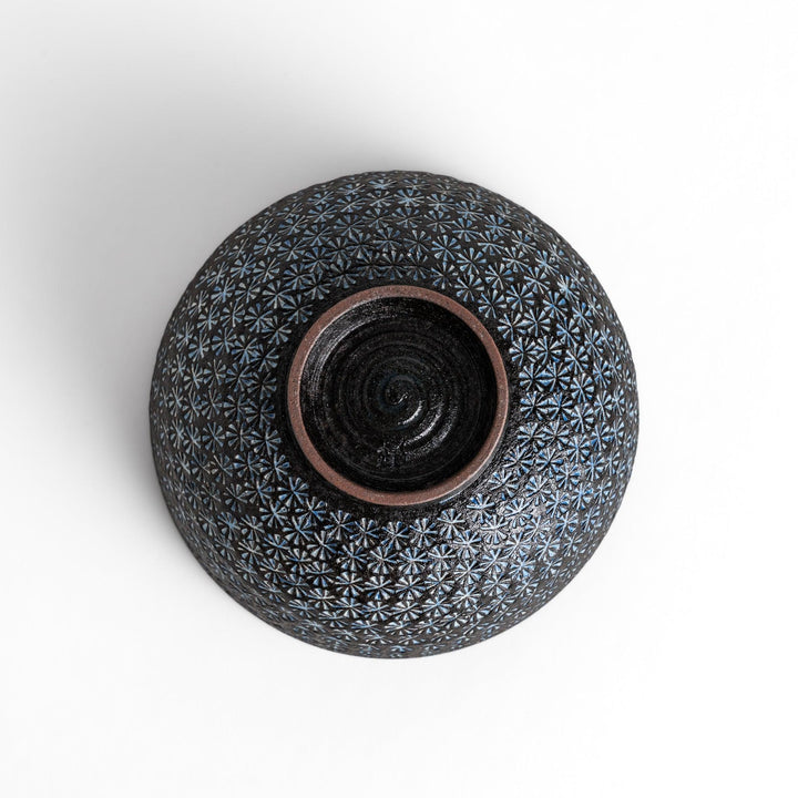 Stunning black Matcha bowl featuring a mesmerizing mosaic-like pattern, perfect for a traditional Japanese tea ceremony.