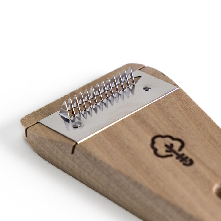 Nagomi Damascus utility knife with patterned blade and striped wooden handle offering precise everyday cutting.