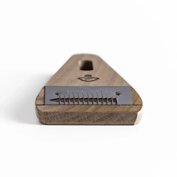 Nagomi Damascus utility knife with patterned blade and striped wooden handle offering precise everyday cutting.