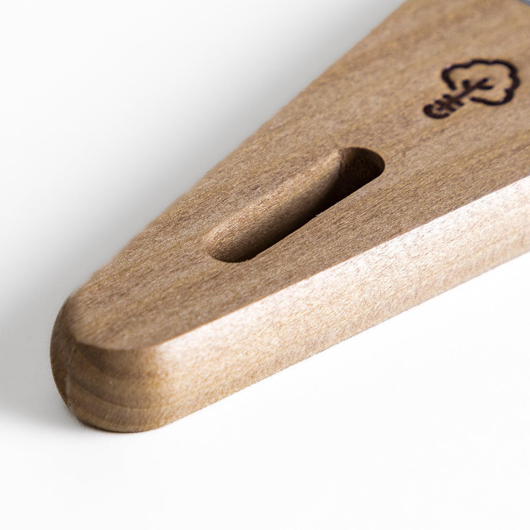 Nagomi Damascus utility knife with patterned blade and striped wooden handle offering precise everyday cutting.