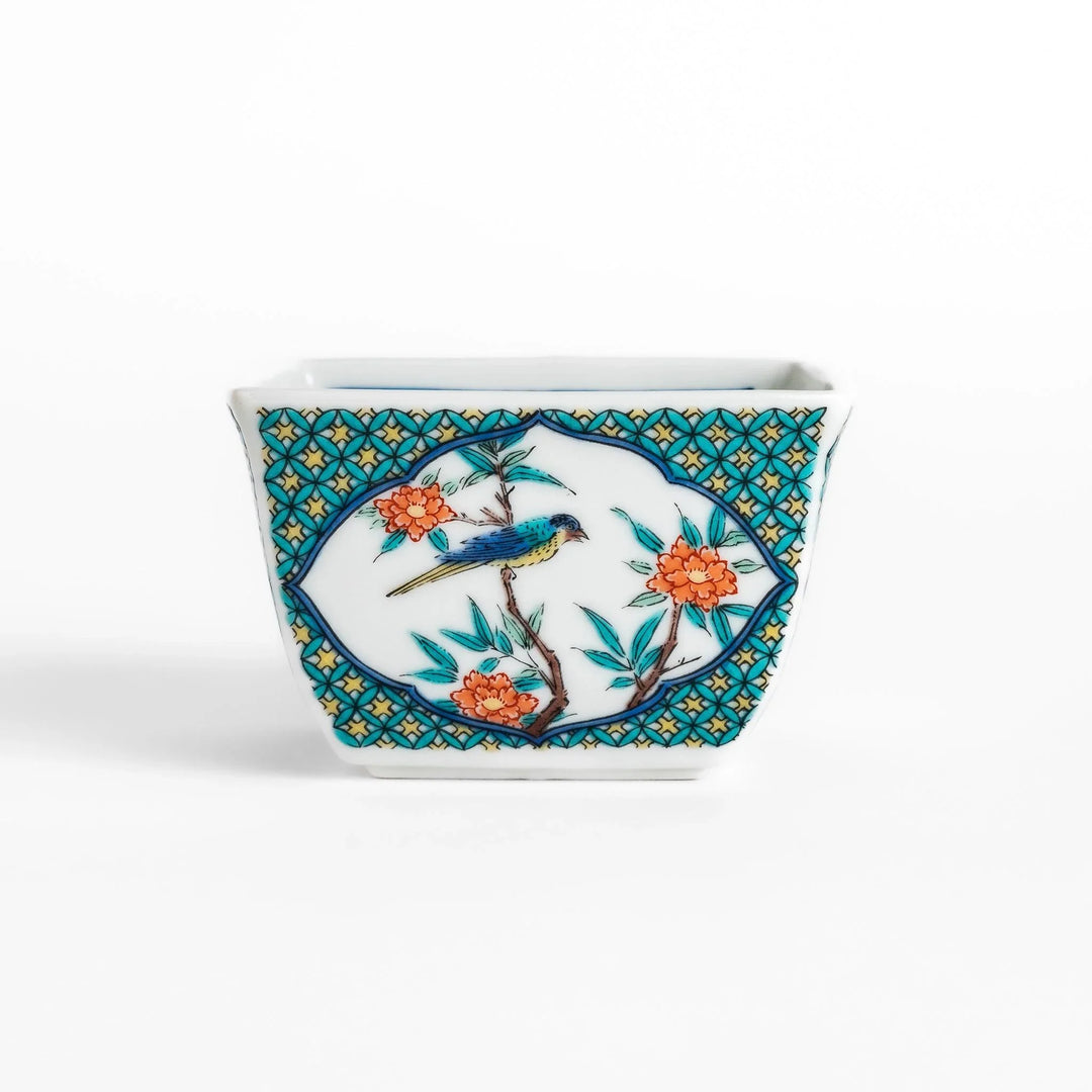 Traditional flower and bird design adorns this elegant condiment bowl, framed with intricate blue patterns.