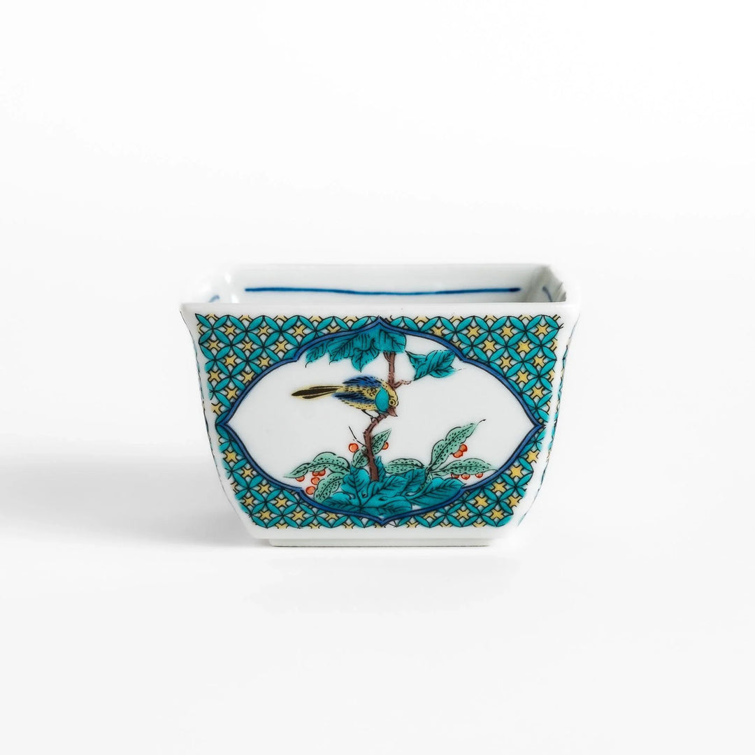 Traditional flower and bird design adorns this elegant condiment bowl, framed with intricate blue patterns.