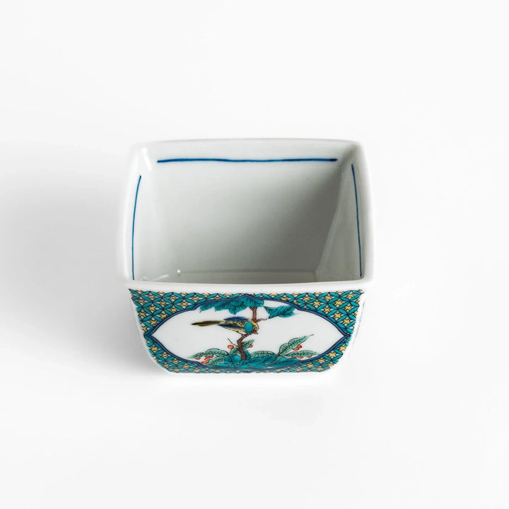 Traditional flower and bird design adorns this elegant condiment bowl, framed with intricate blue patterns.